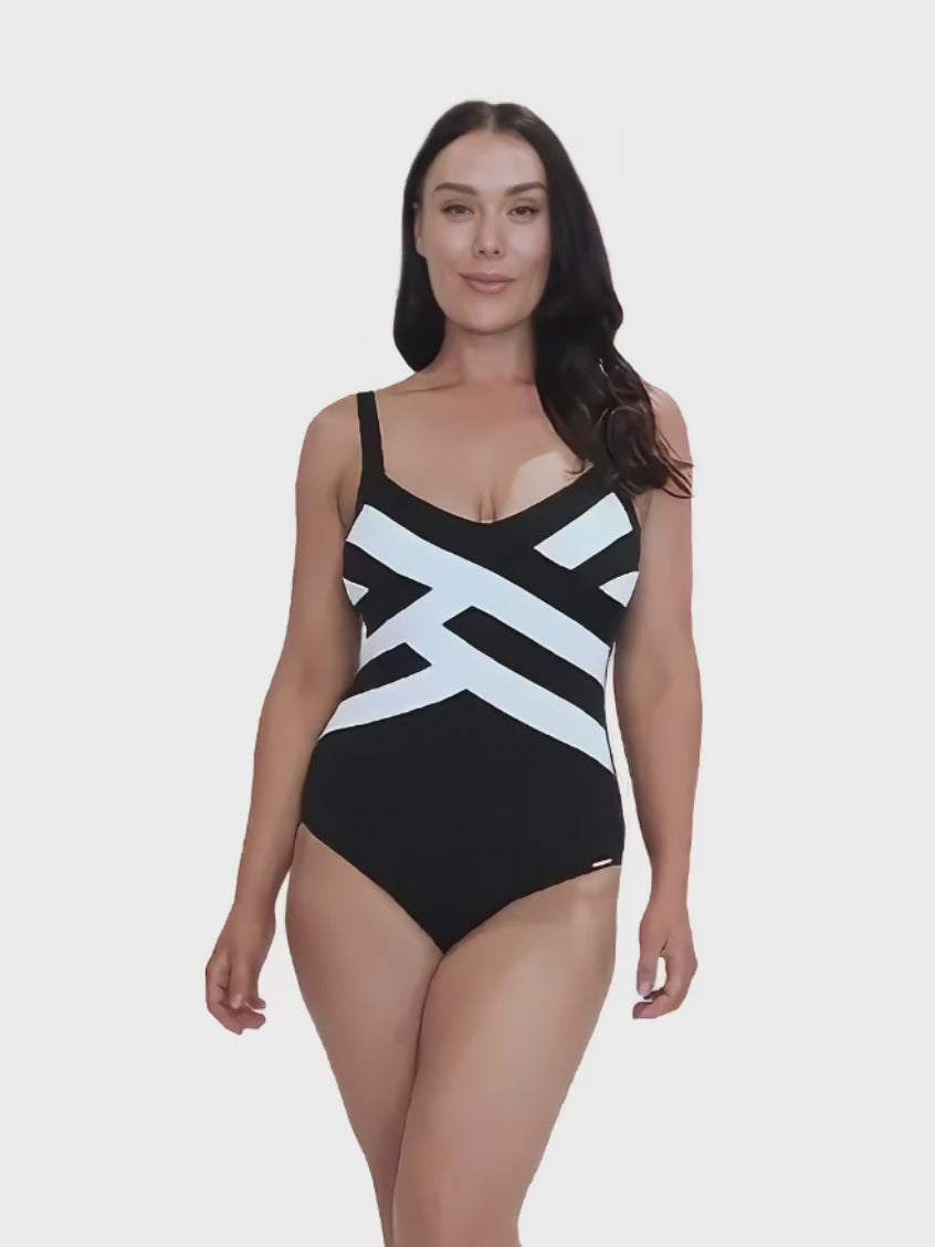 model wearing textured black and white criss cross one piece swimsuit