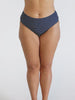 Model in studio showing off high rise navy white dots swim pant
