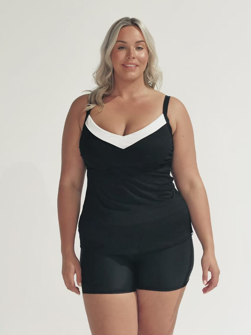 model wearing black and white textured tankini top and matching shorts