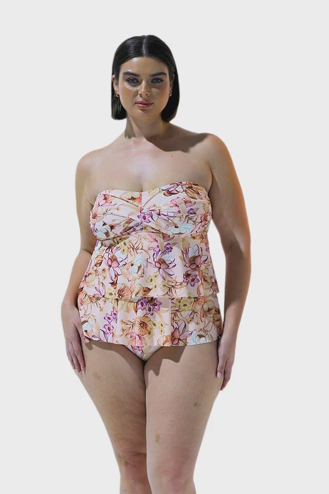 Brunette model wearing blush pink floral tiered tankini swim top