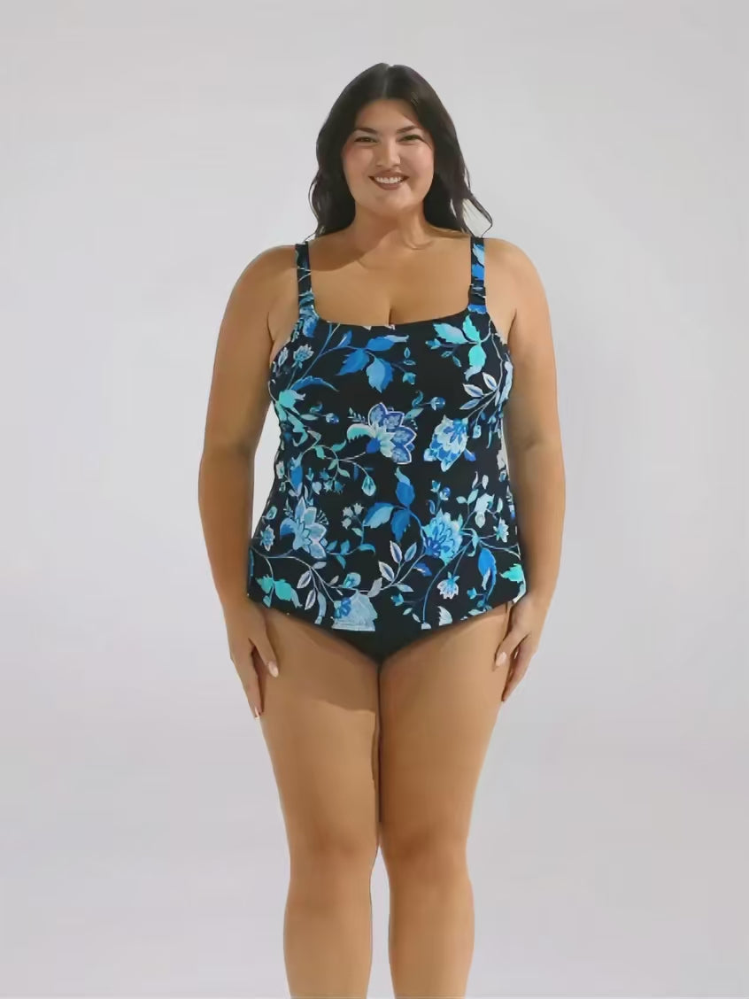 Brunette model in studio wearing a floral blue tankini top 