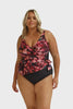 Model wearing pink, plum and black floral crossover one piece swimsuit