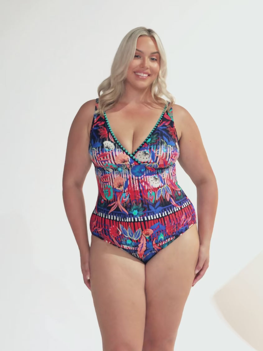 model wearing bright coloured floral one piece