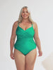 model wearing metallic green criss cross one piece