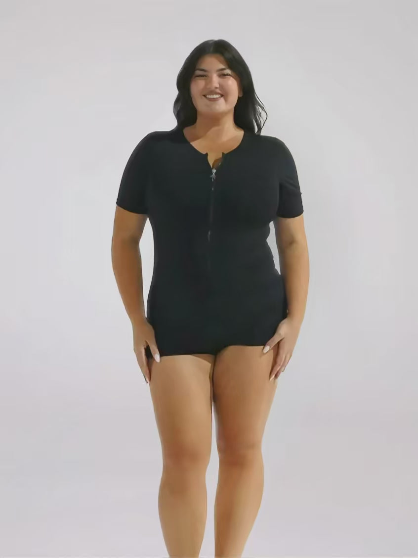 Brunette model in zip front boyleg one piece in chlorine resistant 