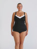 Blonde woman wearing a underwire tankini top with white trim and textured fabric