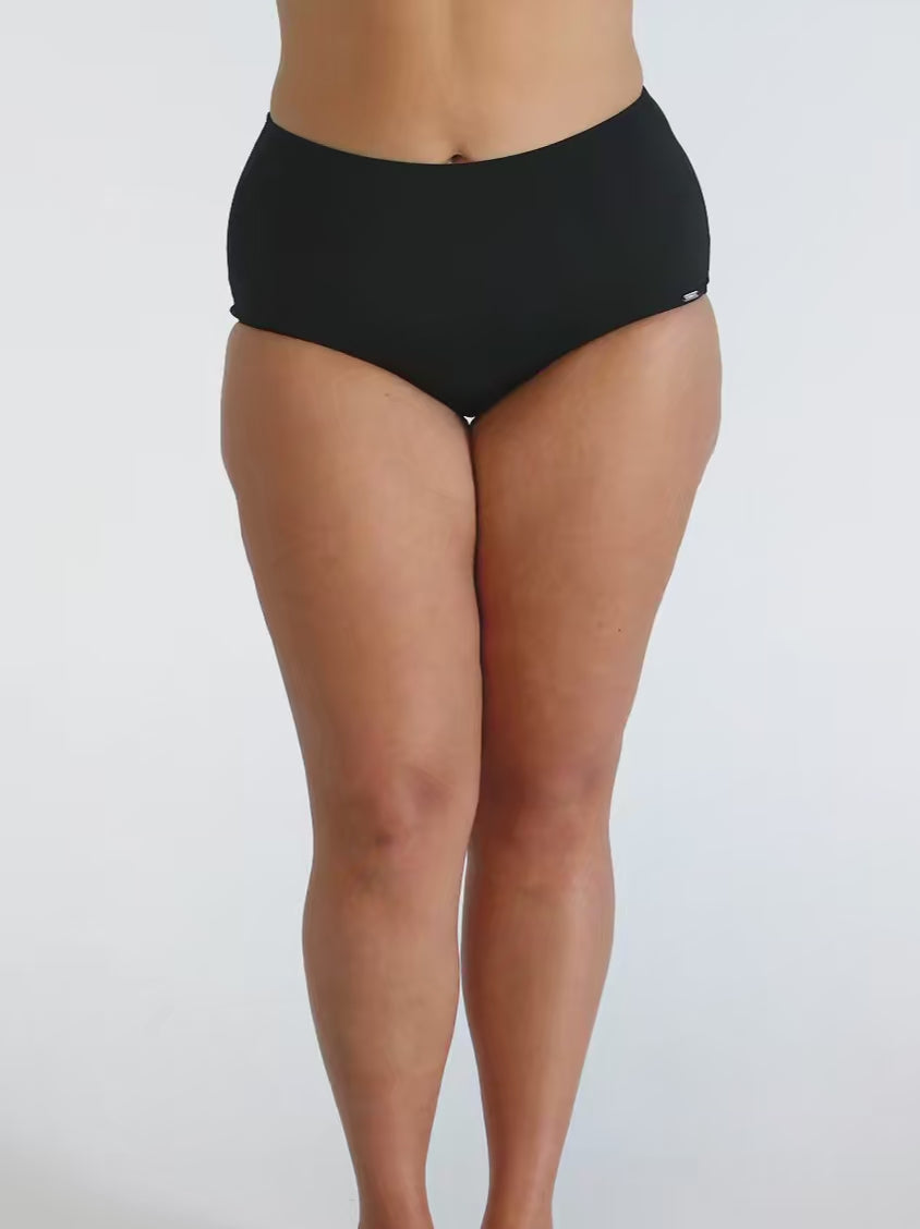 Woman in studio wearing high waisted chlorine resistant pant