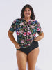 Model in studio wearing a floral short sleeve rash vest with full zip front detail