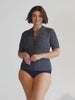 model wearing navy and white dots short sleeve rash vest and navy bottoms