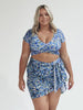 model wearing blue floral wrap sarong and matching bikini