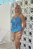 Blonde model wearing blue patterned tiered tankini and pant