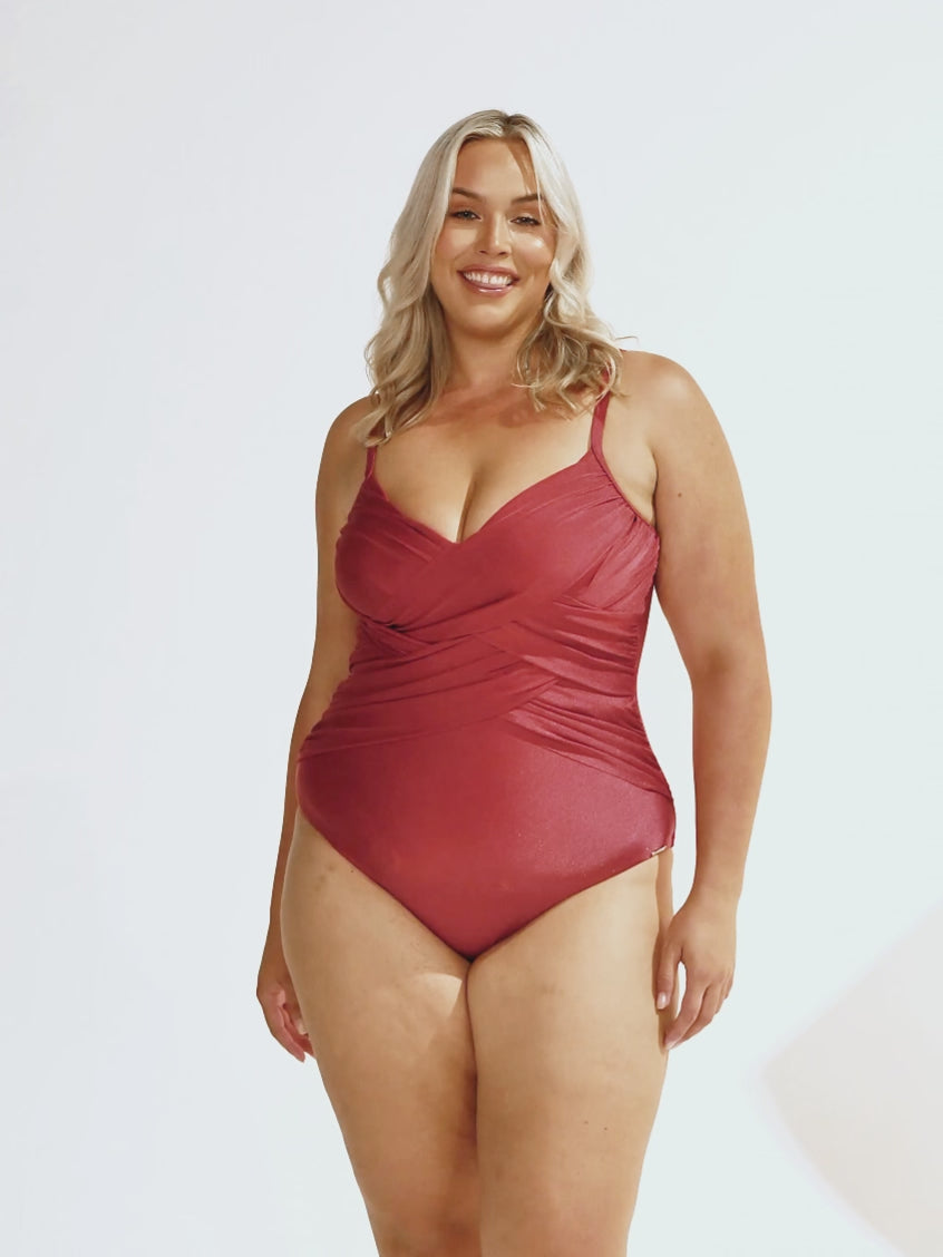 Blonde model wearing a metallic criss cross one piece