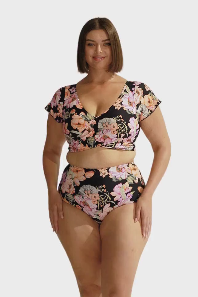 Brunette model wears black based floral tummy control high waisted swim pant
