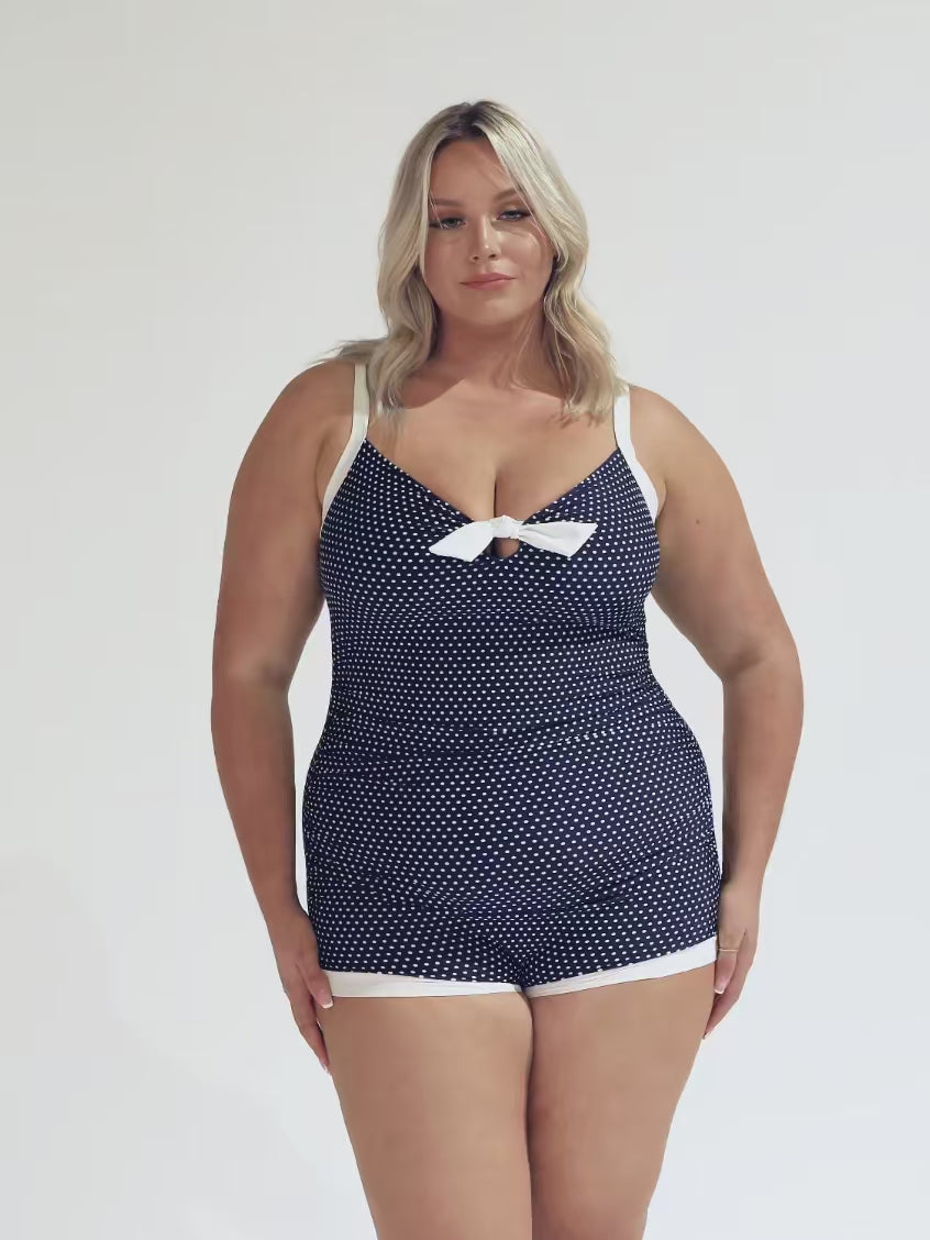 model wearing navy and white dots boyleg one piece