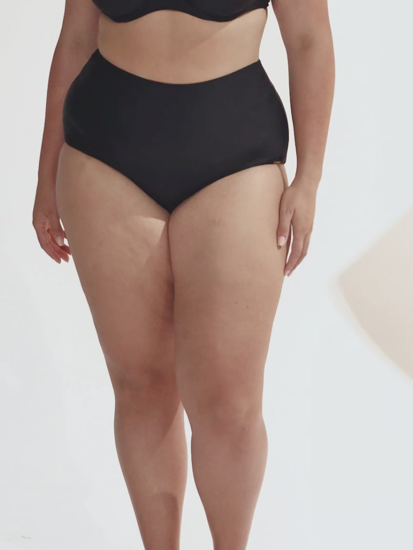 model wearing black high waisted bikini bottom