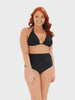 model wearing black ruched swim pant with matching bikini top