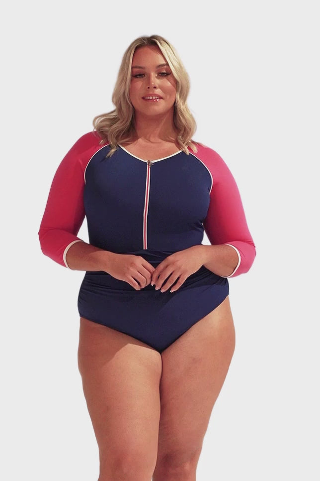 Model wearing navy and pink short sleeve swimsuit