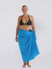 Blonde model in studio wearing pom pom sarong in blue colour