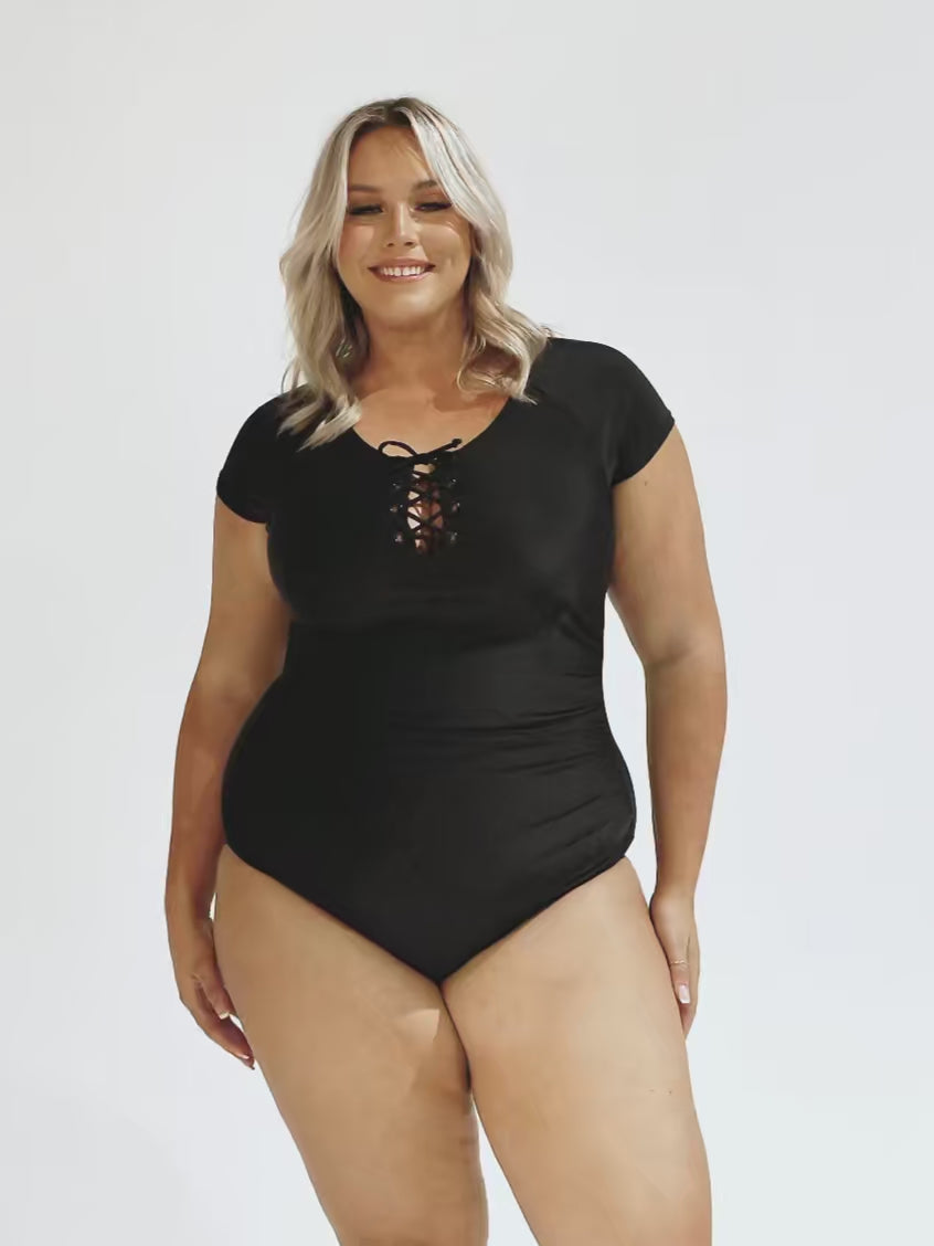 Model in studio wearing a short sleeve tie front one piece