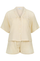 ghost mannequin of sand colour short set, short sleeve button through with matching short pants