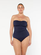model wearing navy textured bandeau swimsuit