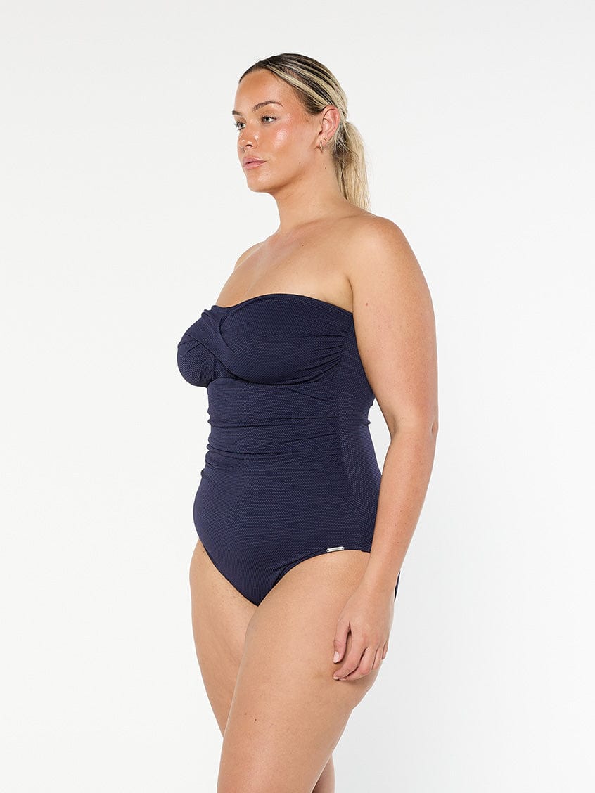model showing side of navy strapless swimsuit