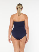 model showing back of textured navy one piece swimsuit