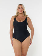 model wearing black scooped one piece
