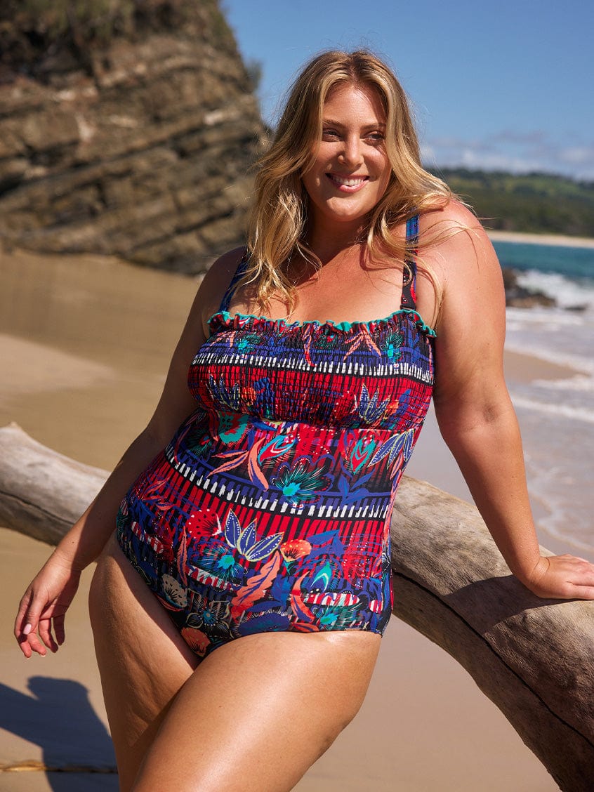 model wearing multicoloured shirred one piece at beach