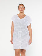 model wearing white mesh beach cover up