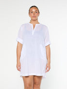 model wearing white over shirt dress