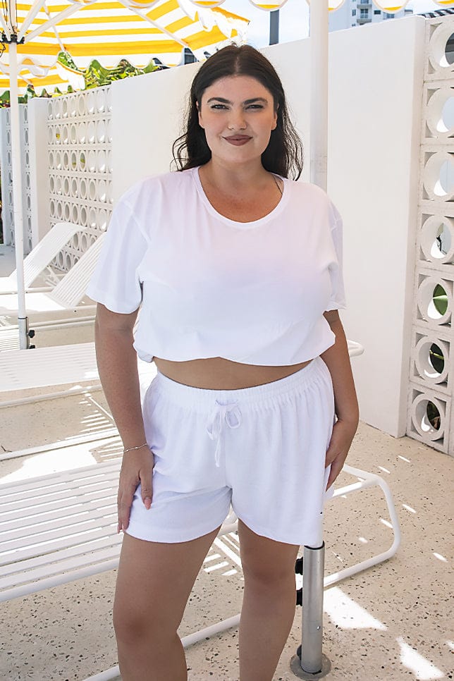 model wearing white terry towelling shorts with drawstring
