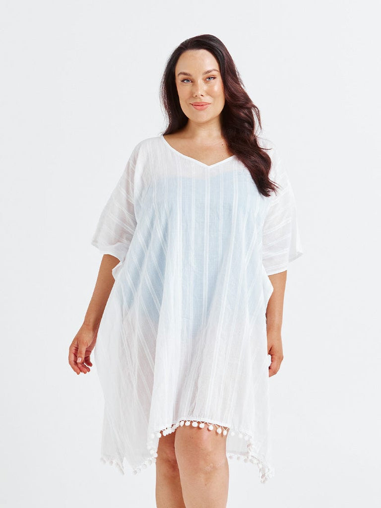 Brunette model in studio wearing white cotton kaftan coverup