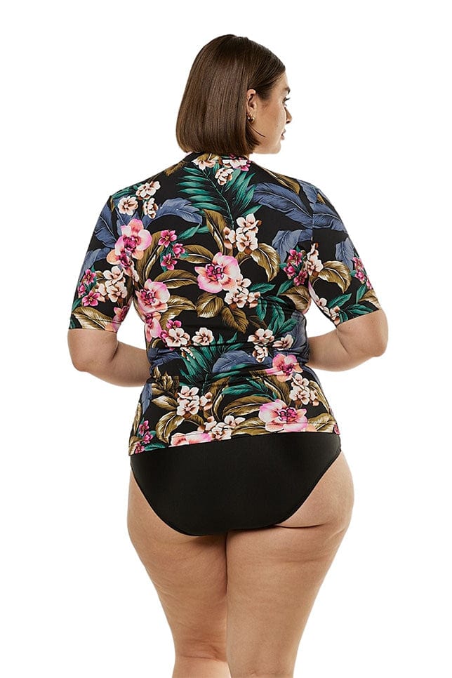 Brunette model showing back of black floral rash vest
