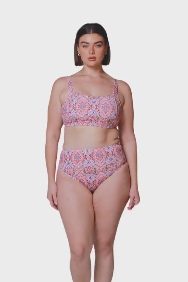 brunette model wearing pink mosaic high waisted and high cut bikini bottom