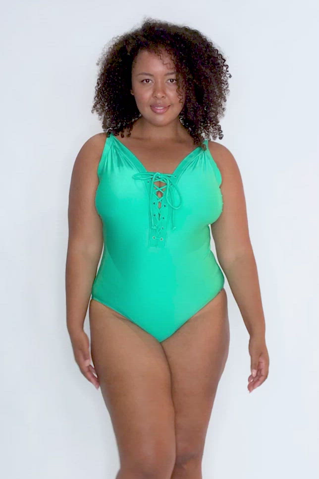 video of model wearing green lace up one piece swimsuit