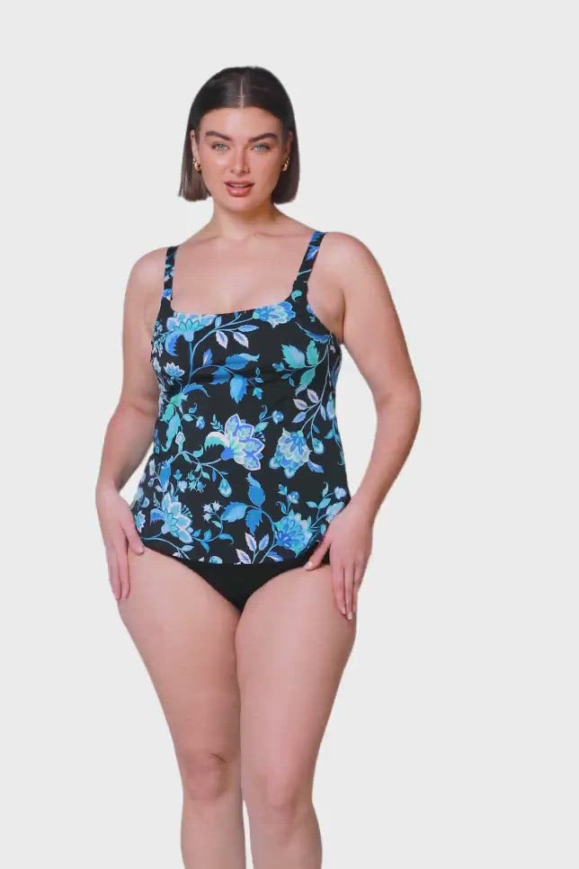 brunette model wearing chlorine resistant tank tankini top with blue and black floral details