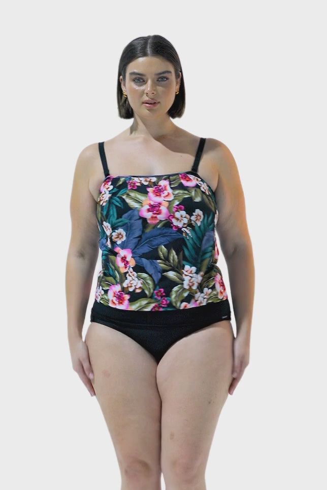 Brunette model wearing floral flouncy tankini top