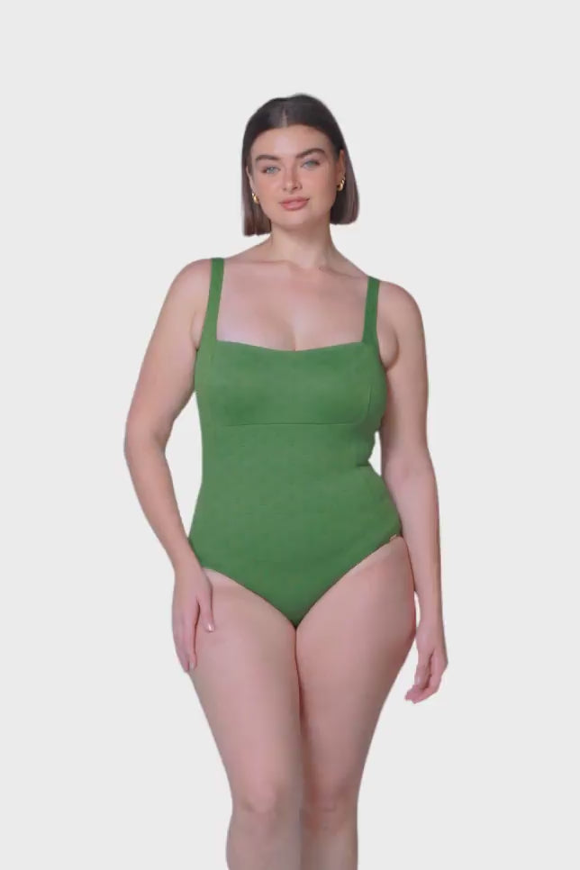brunette size 14 women wearing olive green square neck one piece with a low back