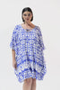 Brunette model wearing blue kaftan swim coverup
