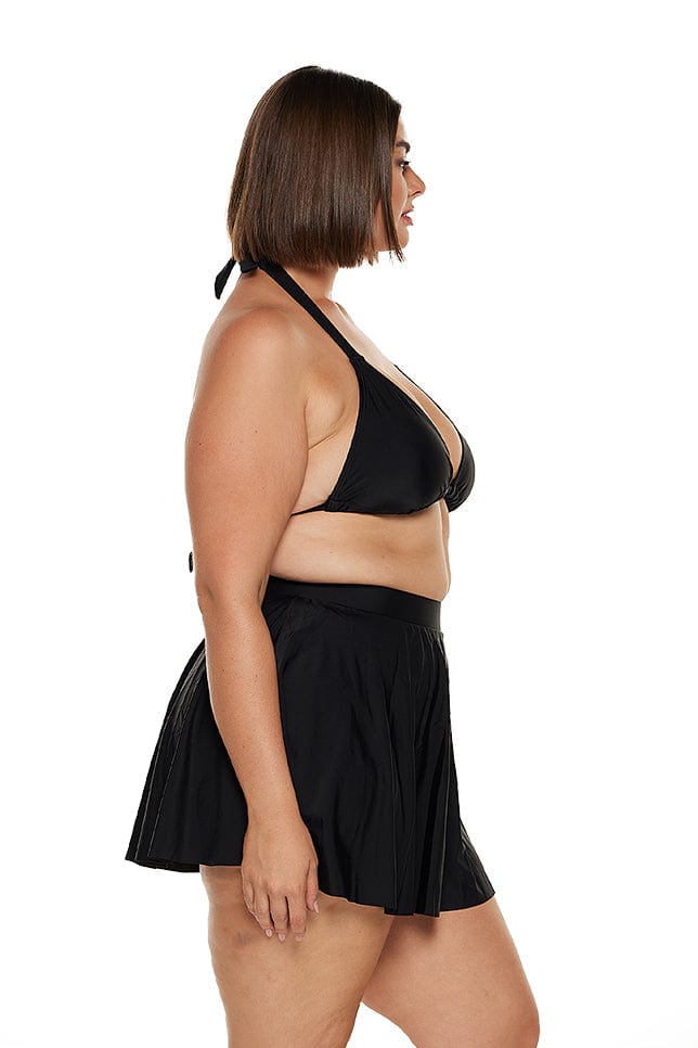 Brunette model wears high waisted retro style swim skirt in black