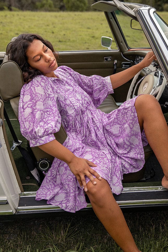 Model sitting in car wearing Model wearing Lilac Boho Mini Dress