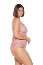 Brunette women wears salmon pink one piece with keyhole neckline and adjustable back straps