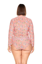 brunette model wears flattering long sleeve rash vest in pink floral print