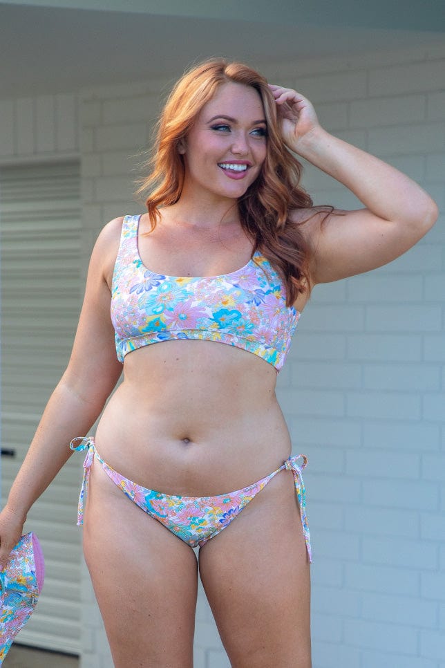 red head model wearing reversible bikini top and bottoms with tie sides in retro print
