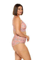 Brunette model wearing pink floral tummy control high waisted bikini bottoms
