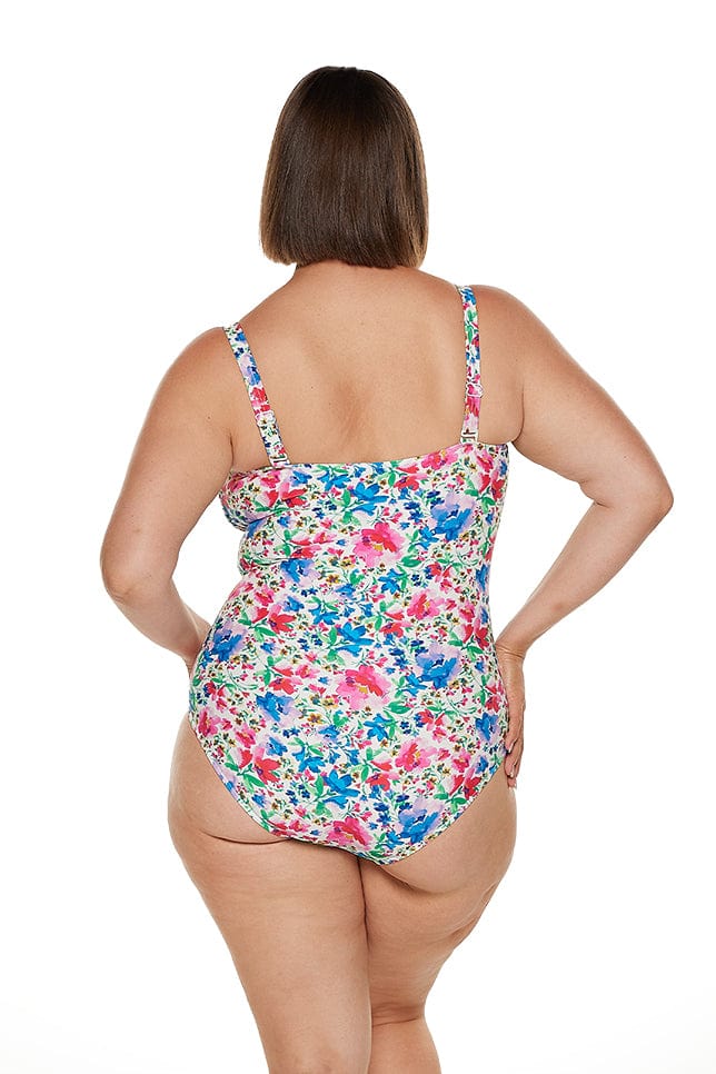 brunette model wears ladies vibrant floral one piece with shirring and removable straps