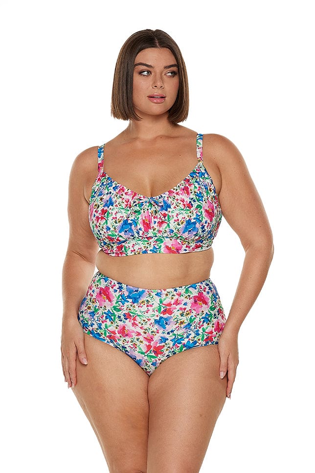 Brunette model wears bright floral underwire bikini top with adjustable tie back