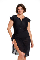 Brunette model wears long black beach skirt in mesh fabric