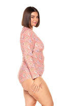 brunette model wearing salmon pink floral rash vest with full length sleeves and full front zip